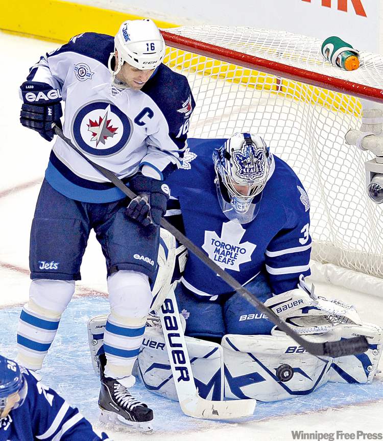 REUTERS
Mike Cassese / reuters
Leafs goalie James Reimer makes a save behind Jets forward Andrew Ladd.