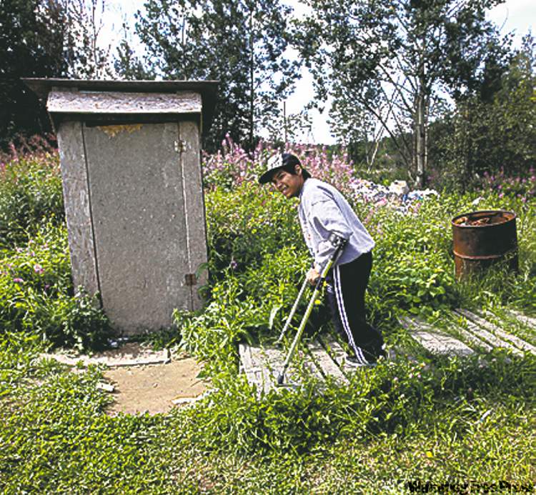 30 year old Kevin Taylor who has Cerebral palsy heads to the outhouse on his crutches at his home in St Theresa Point First Nation- His mother Alice has filled a Human Rights to get proper services for her son on the reservation. Their home has no running water- See Mary Agnes No Running Water Feature � August 19, 2011 (JOE BRYKSA / WINNIPEG FREE PRESS)