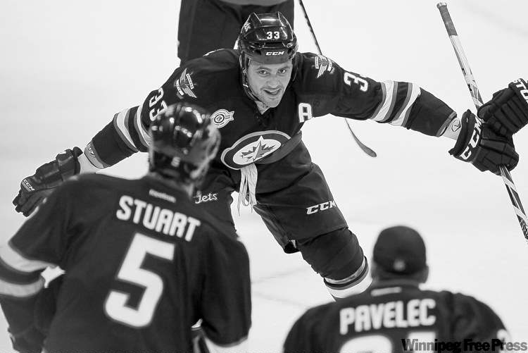 JOHN WOODS
Winnipeg Jets defenseman Dustin Byfuglien (33) celebrates a winn over the Carolina Hurricanes with Mark Stuart (5) and Ondrej Pavelec (31) in third period action at MTS Centre in Winnipeg Saturday, October 22, 2011. (John Woods/Winnipeg Free Press)