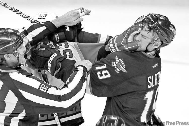 JOHN WOODS
John Woods / Winnipeg Free Press archives
Jets� Jim Slater (19) and Hurricanes� Jeff Skinner get in each other�s grille last Saturday. Slater isn�t letting a concussion change his game.