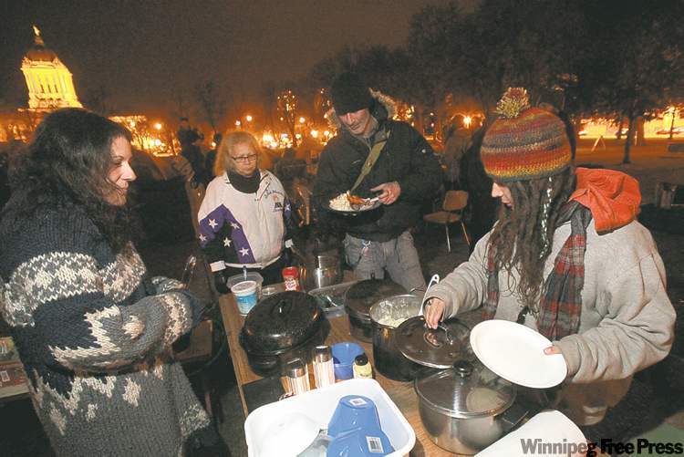 MIKE DEAL / WINNIPEG FREE PRESS
A hot meal cooked at an Occupy Winnipeg supporter's home is served at the Memorial Park camp.