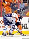 Yong Kim / Philadelphia Daily News / MCT
Philly's Claude Giroux (right) struggles for possession of the puck with Winnipeg's Tobias Enstrom.