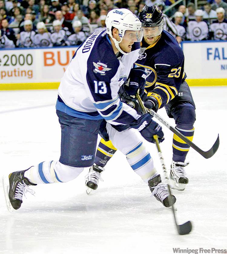 CP
David Duprey / the associated press
Winnipeg�s Kyle Wellwood (left) unloads a shot under pressure from Buffalo�s Ville Leino on Tuesday.