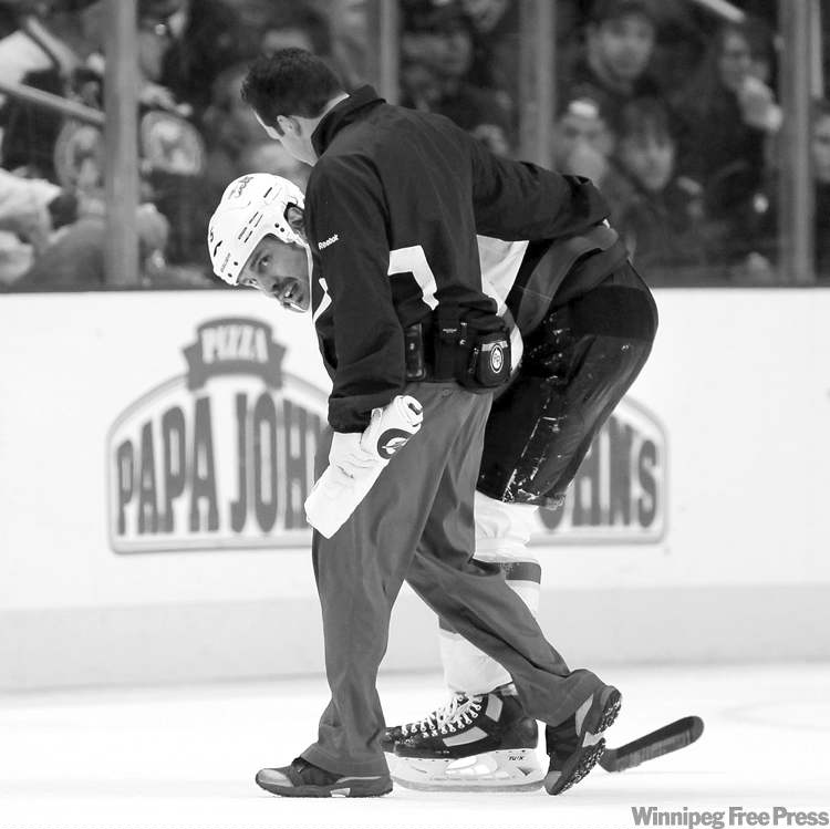 CP
Terry Gilliam / the associated press
Jets blue-liner Mark Stuart is helped off the ice after being rammed into the boards during the third period Saturday night. Stuart said he was OK after the game.