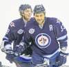 BORIS MINKEVICH/ WINNIPEG FREE PRESS
Dustin Byfuglien (in front of teammate Alexander Burmistrov) is all smiles after lighting the lamp in the first period Monday night at the MTS Centre.
