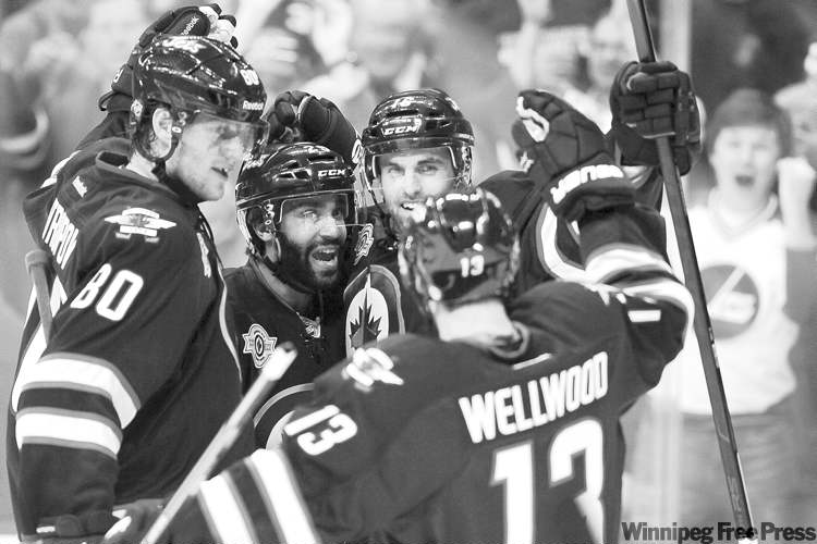 CP
John Woods / the canadian press archives
Winnipeg�s Andrew Ladd (rear), Johnny Oduya (centre), Nik Antropov (80) and Kyle Wellwood celebrate a goal during a textbook win over Tampa Bay on Monday.