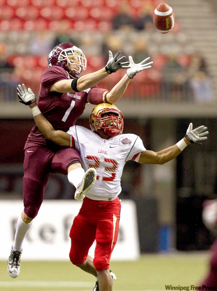 Darryl Dyck / The Canadian Press
McMaster Marauders receiver Mike DiCroce leaps for the catch over Laval Rouge et Or DB Maximilien Ducap Kamara at the CIS Vanier Cup in Vancouver in 2011.