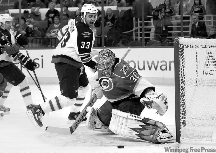 CP
Gerry Broome / The Associated Press
Hurricanes goalie Cam Ward defends the goal as Jets defenceman Dustin Byfuglien makes one of his frequent forays into enemy territory.