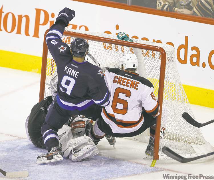 TREVOR HAGAN / WINNIPEG FREE PRESS
Winnipeg�s Evander Kane crashes into the New Jersey net, obliterating goaltender Johan Hedberg and defenceman Andy Greene in the process.