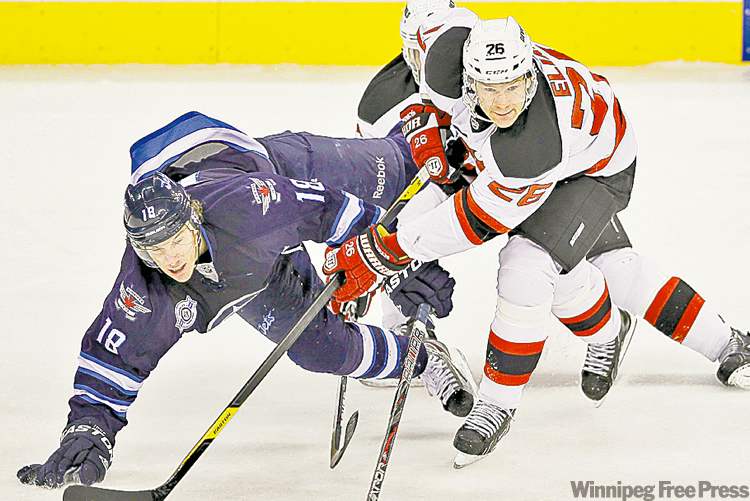 john woods / the canadian press
New Jersey Devils forward Patrik Elias takes out Winnipeg Jets forward Bryan Little during an NHL game at the MTS Centre in Winnipeg on Saturday.