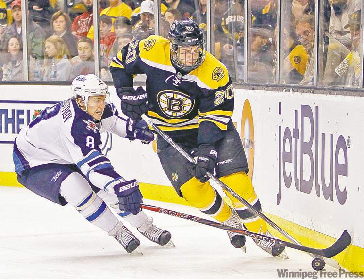 Michael Dwyer / the associated press archives
Winnipeg Jets forward Alex Burmistrov checks Boston Bruins' Daniel Paille during game in Boston Nov. 26. The Bruins won 4-2.