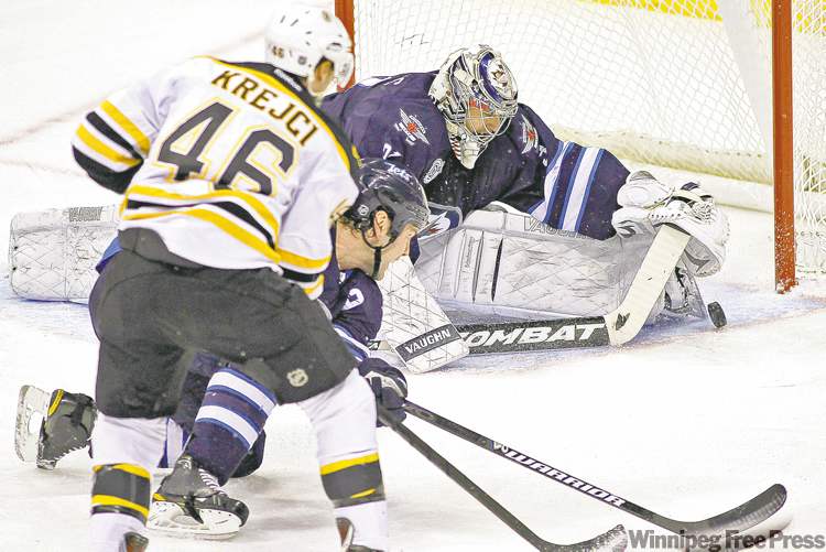 WINNIPEG FREE PRESS
John Woods / WINNIPEG FREE PRESS
Winnipeg Jets goaltender Ondrej Pavelec gets a toe on Boston Bruins forward David Krejci�s shot as Jets defenceman Mark Stuart runs interference.