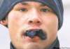 A young sniff addict on Main Street stuffs a solvent-soaked sock in his mouth to get a more powerful dose of fumes. Many addicts are trapped in a mental and medical hell.