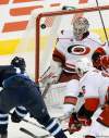 MIKE DEAL / WINNIPEG FREE PRESS
Jets centre Bryan Little snaps one past Hurricanes goaltender Cam Ward in the second period.