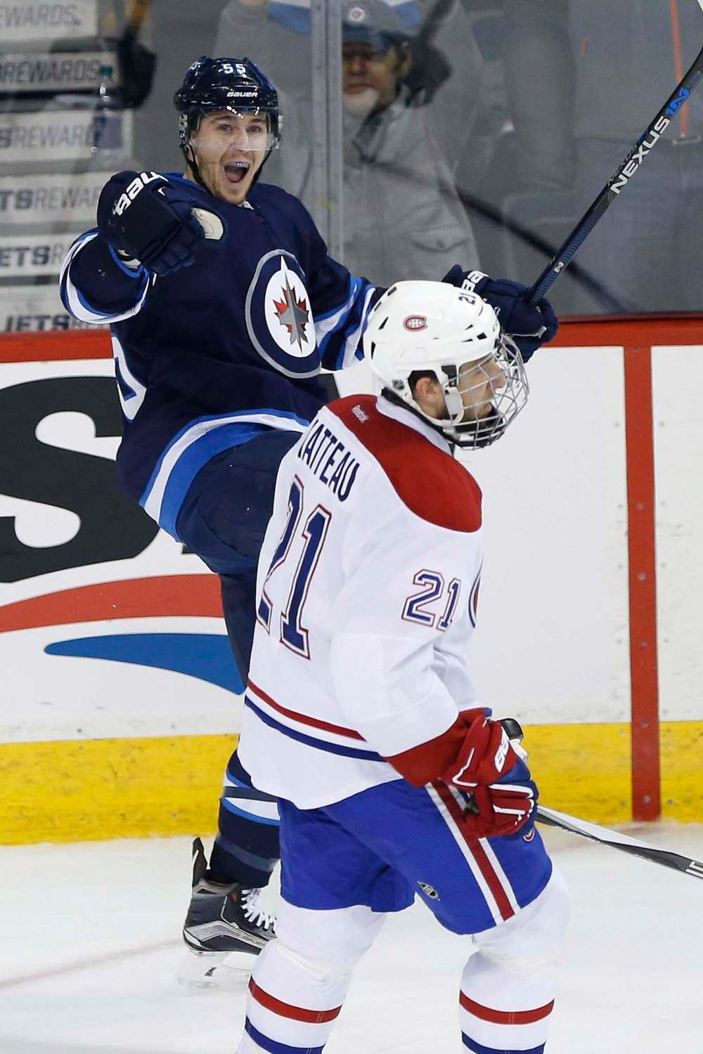 John Woods / The Canadian Press
Winnipeg Jets centre Mark Scheifele celebrates his second goal of the game as the Montreal Canadiens’ Stefan Matteau skates by during third-period action Saturday. It proved to be the game-winner and Scheifele went on to complerte a hat trick.