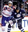 TREVOR HAGAN / WINNIPEG FREE PRESS
Jets' Dustin Byfuglien shoves Habs' Max Pacioretty aside as the sticks get higher in the third period Thursday night at the MTS Centre.