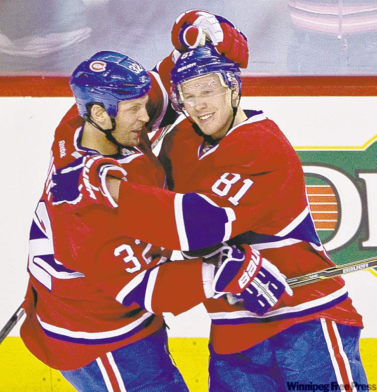 Dave Sidaway / postmedia news
Lars Eller (right) is congratulated by teammate Travis Moen after scoring the first of his four goals Wednesday.