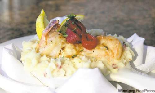 Mike Deal / Winnipeg Free press Archives
A feature at Bistro 1800 at the Hilton Suites is St. Jacques sautéed jumbo prawns and scallops simmered in a riesling cream sauce. Served in a crown of whipped potatoe and topped with an Asiago cheese blend. Read on for more of Marion's restaurant picks.