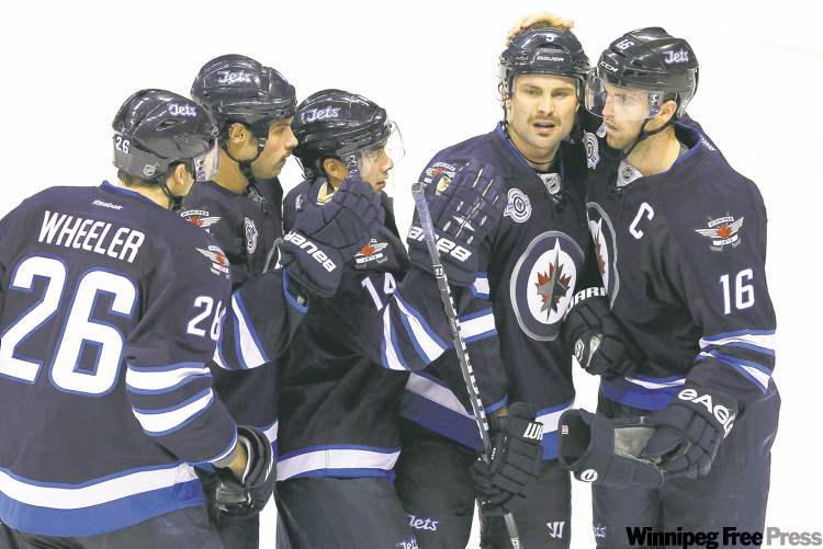 WINNIPEG FREE PRESS
John Woods / WINNIPEG FREE PRESS archives
The Jets look to captain Andrew Ladd and alternate captain Mark Stuart (second right) for leadership on the ice and in the dressing room.