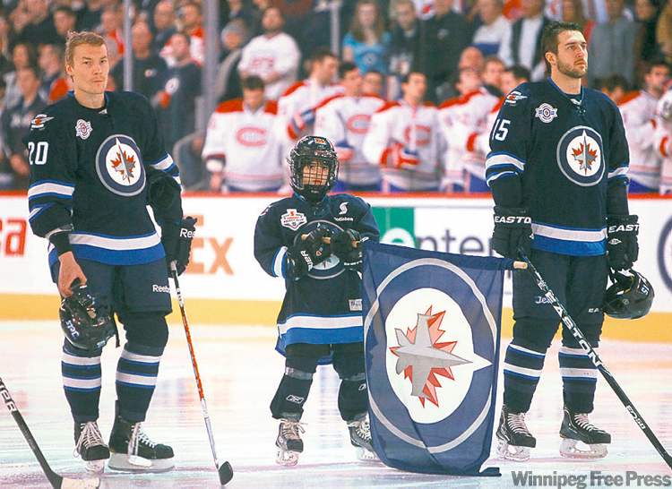 Ashton takes his spot during the national anthem beside Jets Antti Miettinen and Tanner Glass.