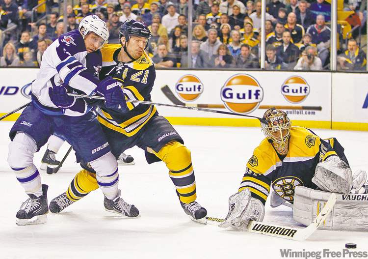 CP
Michael Dwyer / the associated press
Boston goalie Tuukka Rask steers a shot to the corner as Bruins blue-liner Andrew Ference ties up Winnipeg forward Kyle Wellwood Tuesday night.
