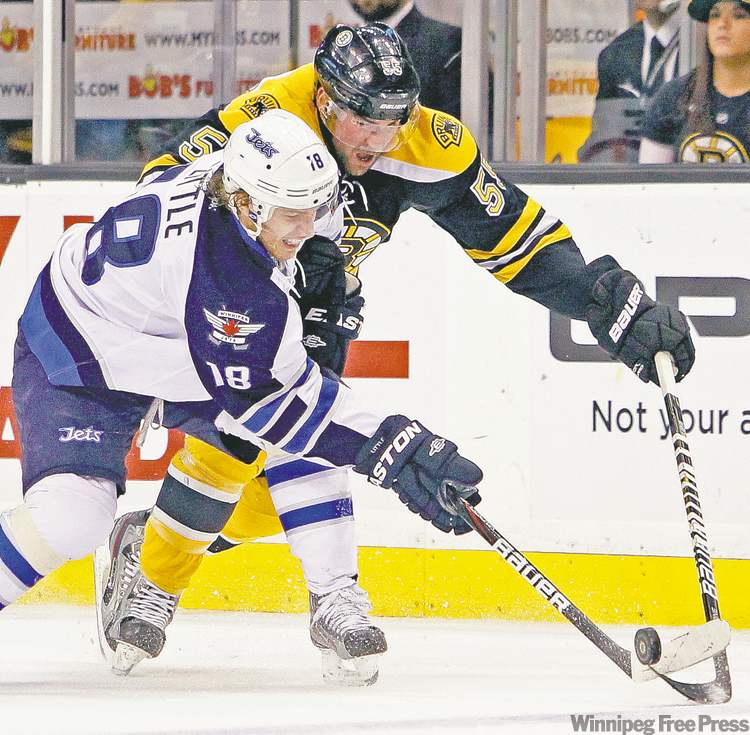 Michael Dwyer / the associated press
Winnipeg's Bryan Little (18) battles Boston defenceman Johnny Boychuk for possession of the puck during Tuesday night's action.