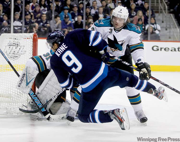 TREVOR HAGAN / WINNIPEG FREE PRESS
Winnipeg Jets winger Evander Kane is given a rough ride by San Jose�s Douglas Murray in front of the Sharks� goal during second-period action.