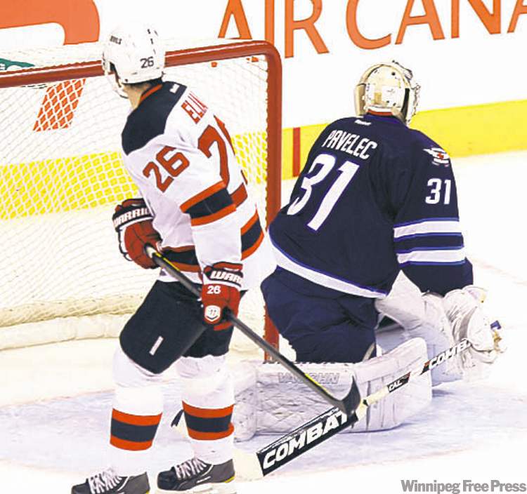 Jets goalie Ondrej Pavelec stones New Jersey�s Patrik Elias on a penalty shot in the third period.