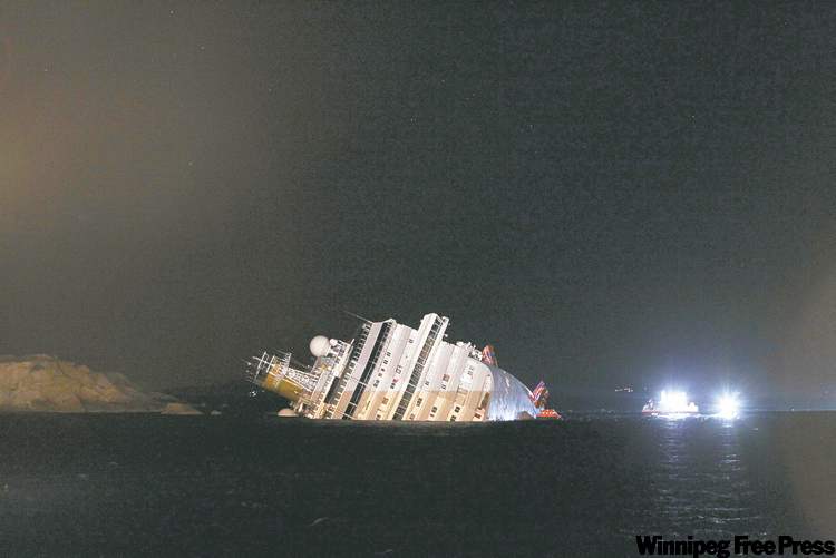 CP
GREGORIO BORGIA / THE ASSOCIATED PRESS
The luxury cruise ship Costa Concordia lies on its side after running aground off the tiny Tuscan island of Giglio, Italy, Saturday.