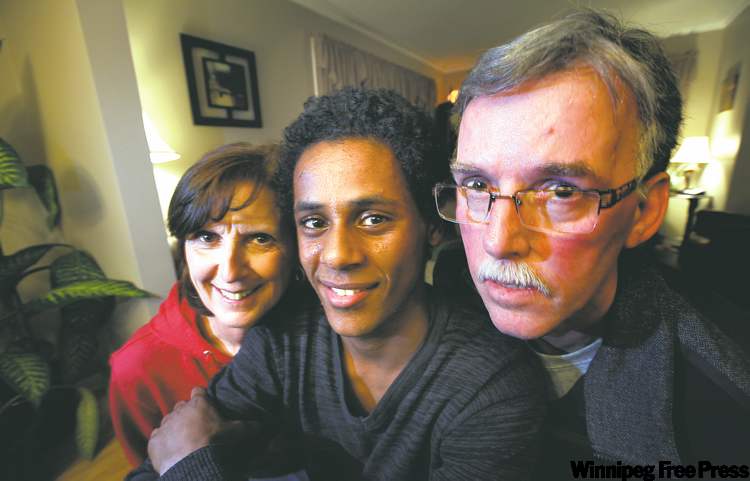 Phil Hossack / Winnipeg Free Press
Lloyd and Sharon Small pose with son Kimon in their Brandon home. Kimon was adopted after being found as a toddler on the streets of Addis Ababa.