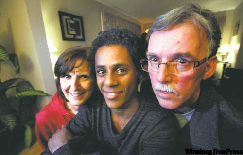 Phil Hossack / Winnipeg Free Press 
Lloyd and Sharon Small pose with son Kimon in their Brandon home. Kimon was adopted after being found as a toddler on the streets of Addis Ababa.