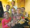 PHIL HOSSACK / WINNIPEG FREE PRESS
Robinson Joseph, his wife, Aman Salome Akakpo, and their children (clockwise from bottom left) Clara, Scott, Queen and Gladys relax in their Transcona home.