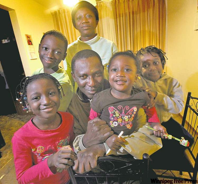 PHIL HOSSACK / WINNIPEG FREE PRESS
Robinson Joseph, his wife, Aman Salome Akakpo, and their children (clockwise from bottom left) Clara, Scott, Queen and Gladys relax in their Transcona home.