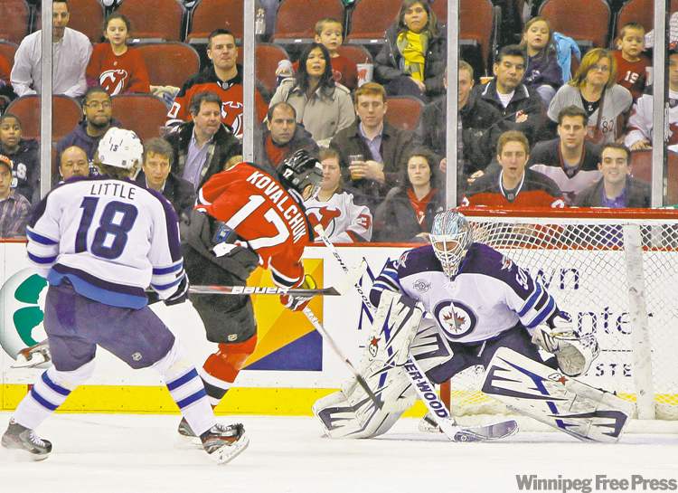 Rich Schultz / the associated press
New Jersey's Ilya Kovalchuk rifles a shot past Winnipeg Jets goalie Chris Mason during first-period action in Newark on Tuesday night.