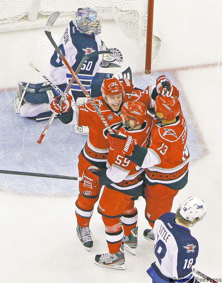 Tribune Media MCT
cris seward / mct
The Carolina Hurricanes� Tim Brent celebrates his game-winning goal with teammates Chad LaRose (59) and Anthony Stewart (13) during the first period against the Winnipeg Jets at the RBC Center in Raleigh, N.C., Monday.