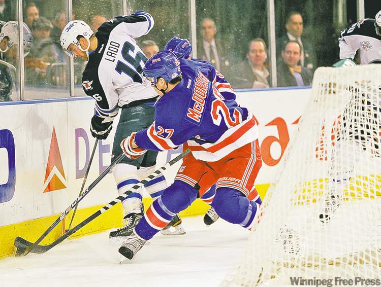 Tribune Media MCT
Errol Anderson / mcclatchey news service
Winnipeg�s Andrew Ladd (left) and Ryan McDonagh of the Rangers battle for possession of the puck during Tuesday night�s action at MSG.