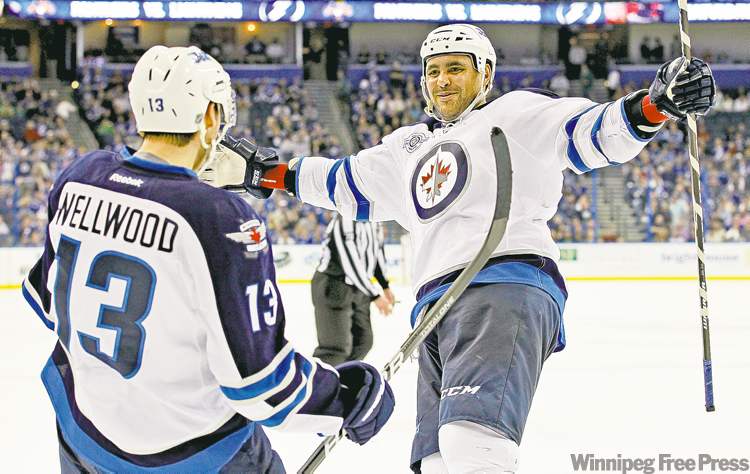 CP
Mike Carlson / the associated press
Overtime hero Kyle Wellwood celebrates his game-winning goal with newly returned teammate Dustin Byfuglien.