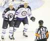 Chuck Myers / MCT 
Jets blue-liner Tobias Enstrom (39) and captain Andrew Ladd protest a slashing penalty on Enstrom by referee Rob Martell Thursday night.