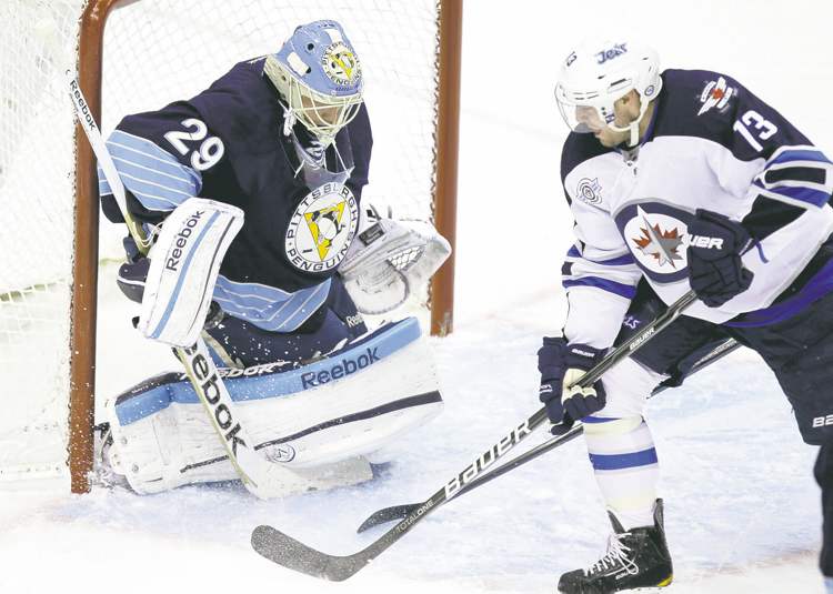 CP
Gene J. Puskar / the associated press
Winnipeg�s Kyle Wellwood puts a backhander past Penguins goalie Marc-Andre Fleury in the opening frame on Saturday.