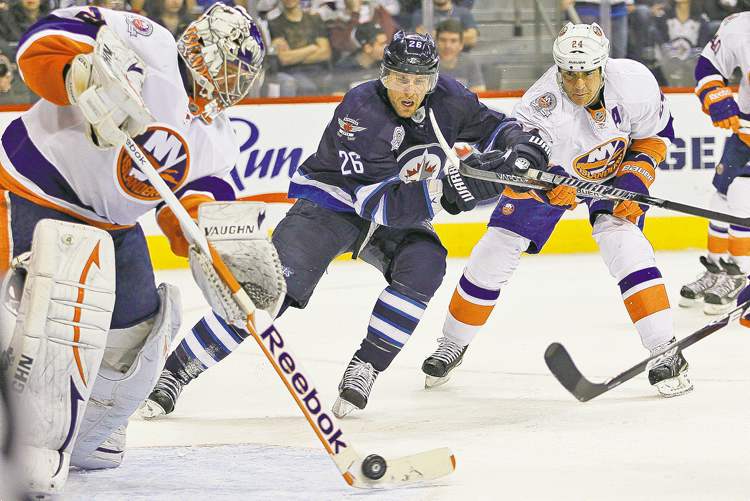 John Woods / The Winnipeg Free Press
Winnipeg Jet Blake Wheeler (26) drives for the puck as New York Islanders' goaltender Evgeni Nabokov clears it from harm's way on Tuesday.