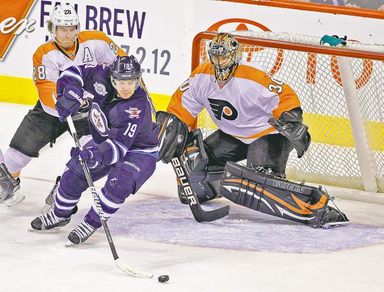 Trevor Hagan / the canadian press
The Jets' Jim Slater angles in front of the Flyers' Claude Giroux and goaltender Ilya Bryzgalov during second-period action in Winnipeg Tuesday.