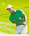 CP
Rob Schumacher / the associated pressTiger Woods chips to the second green during his first-round match Wednesday.