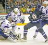 Phil Hossack / Winnipeg Free Press
Tampa Bay Lightning goalie Dwayne Roloson eyes a bouncing puck while Jets winger Evander Kane looks to seize on the opportunity.