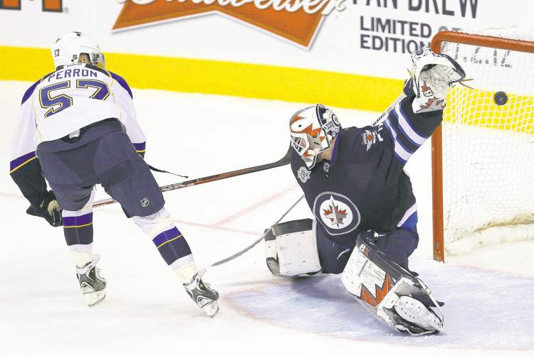 CP
John Woods / The Canadian Press
St. Louis forward David Perron scores the winning goal in the shootout past Jets goalie Chris Mason Saturday afternoon.