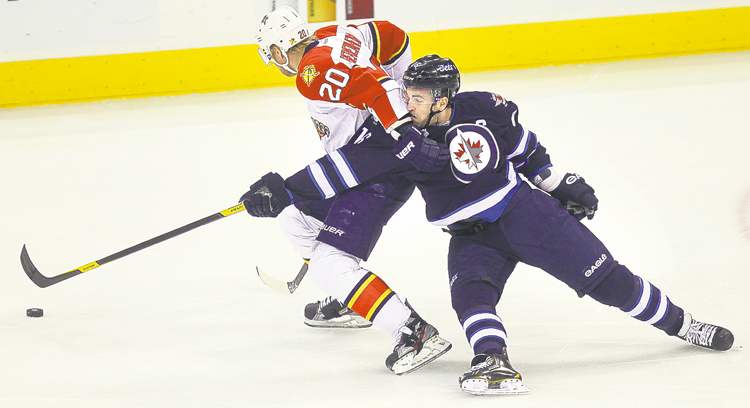 Phil Hossack / Winnipeg Free Press
Jets� Andrew Ladd takes an elbow in the nose from Florida�s Sean Bergenheim.