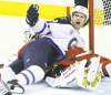 Stuart Gradon / postmedia news
Winnipeg forward Jim Slater pins down Calgary Flames goalie Miikka Kiprusoff during second-period action in Calgary Friday night.
