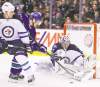 Postmedia PNG
Gerry Kahrmann / postmedia news archvies
Vancouver's Mason Raymond fights for the puck with Winnipeg's Randy Jones Friday in front of goalie Ondrej Pavelec. Pavelec says: 'We've got to change' on the road.