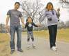 TREVOR HAGAN / WINNIPEG FREE PRESS
Kate Tang, 5, learns to rollerblade with her parents, Tony Tang and Stacy Feng, in Assiniboine Park on Sunday. Today's high is expected to hit 25 C.