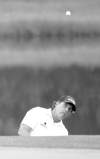 CP
Dave Einsel / the associated pressPhil Mickelson chips to the eighth green while completing his rain-delayed first round of the Houston Open on Friday. Mickelson shot 65 and followed with a 70 later in the day to trail the leaders by two shots.