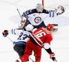 Ellen Ozier / REUTERS
Winnipeg Jets goaltender Chris Mason and teammate Dustin Byfuglien combine to stymie Carolina Hurricanes' Brandon Sutter in the third period.